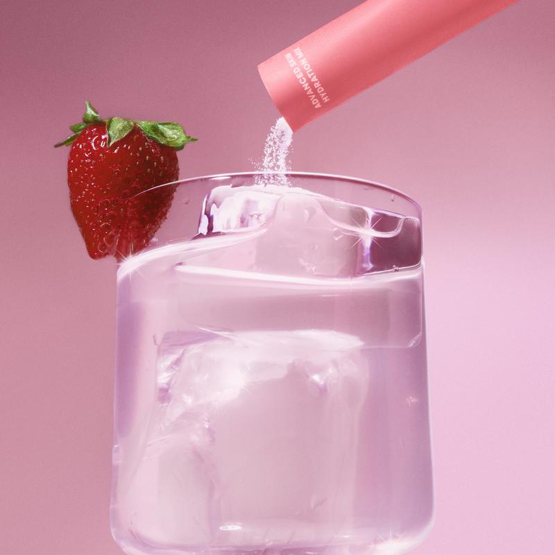 k2o stick poured into a glass with strawberry garnish